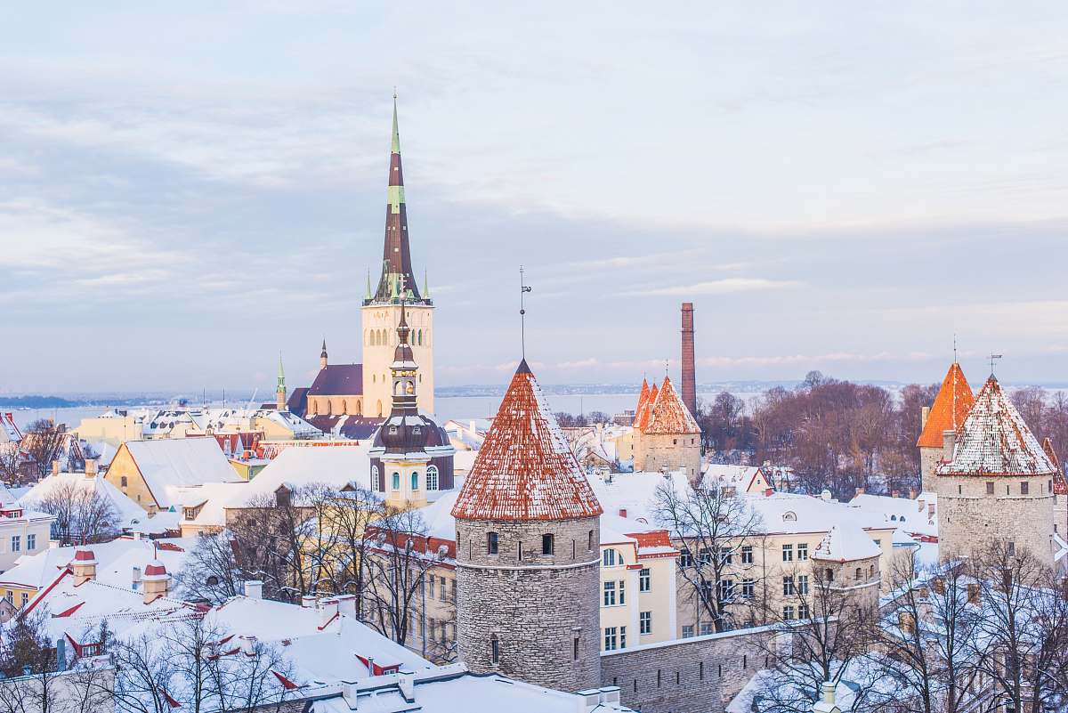 tallinn snow covered brown, white, and gray concrete castle under cloudy skies estonia