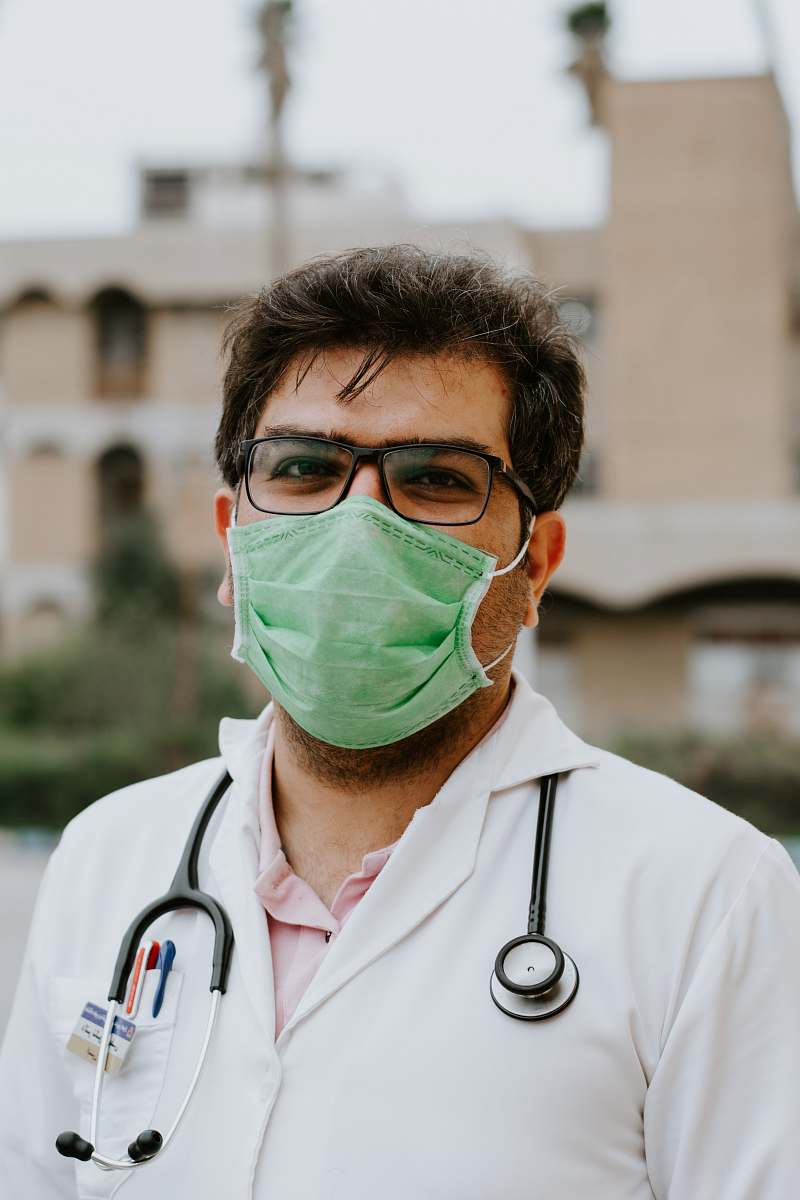 clothing man in white scrub suit wearing green mask lab coat