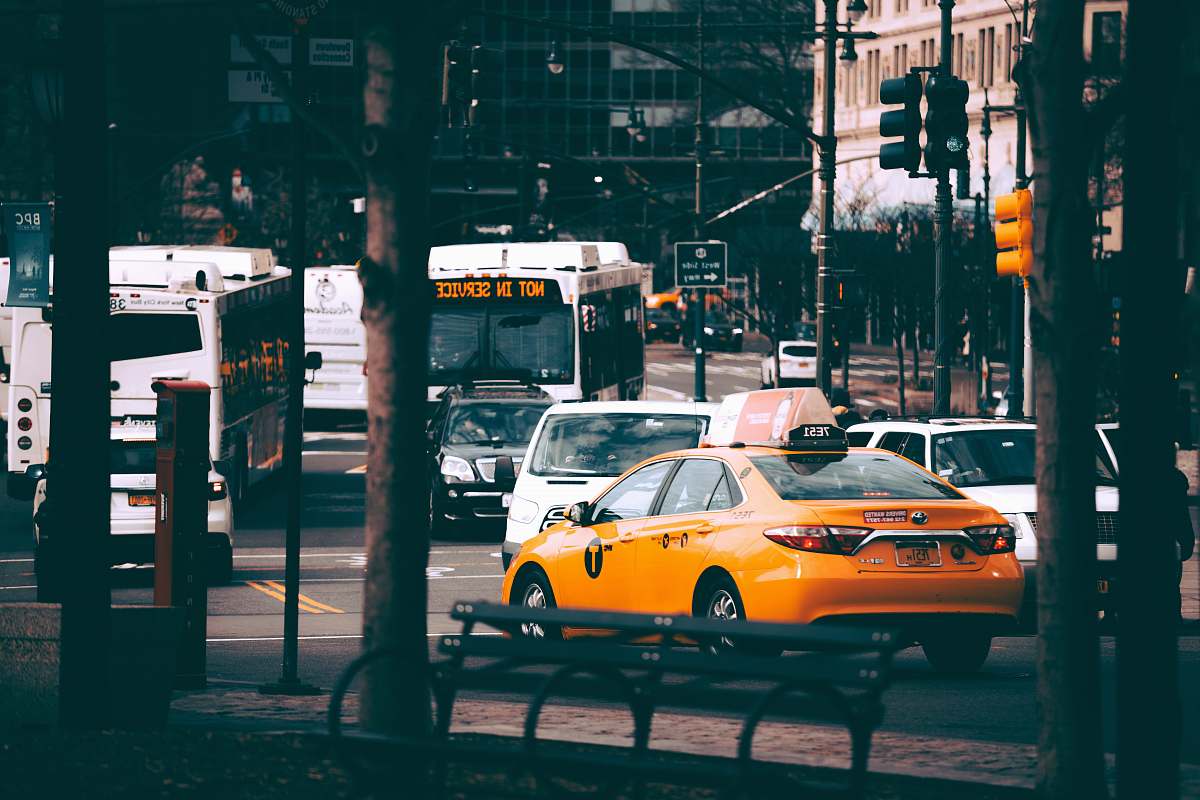 car yellow sedan at road during daytime transportation