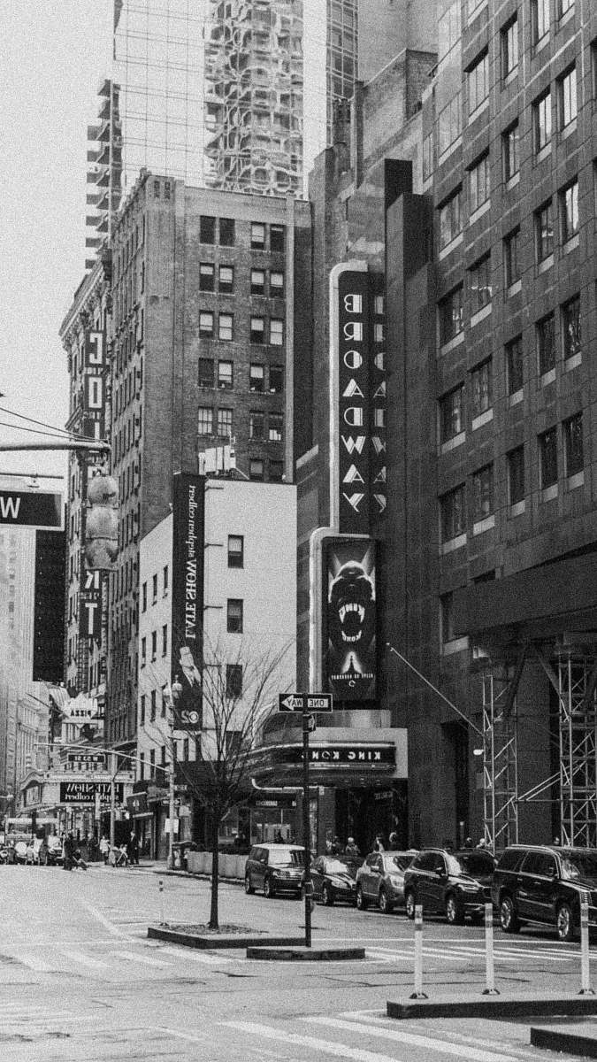automobile grayscale photo of city buildings car