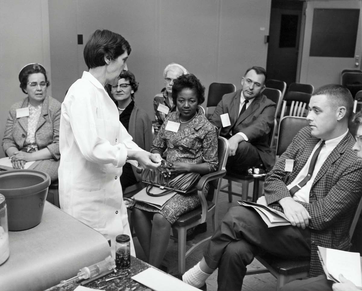 person grayscale photo of people inside room black-and-white