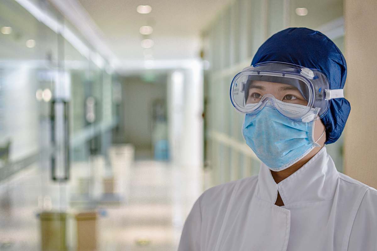 person man in white dress shirt wearing blue face mask apparel