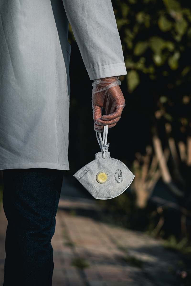 apparel person in white dress shirt and blue denim jeans holding silver round pendant clothing