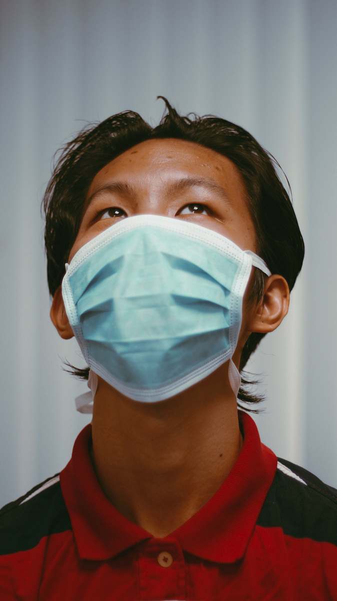doctor woman in red shirt wearing white face mask person