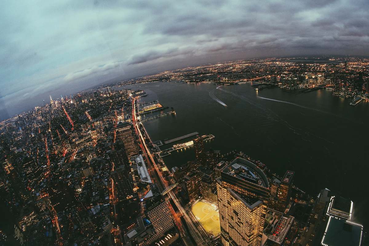outdoors aerial photography of buildings beside calm water at night landscape