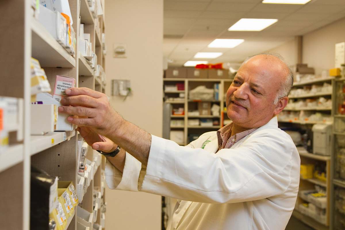 human man in white dress shirt holding white paper shelf