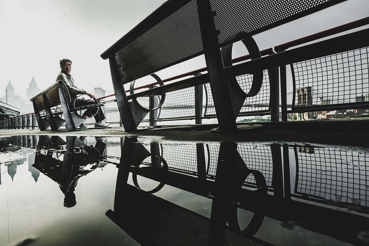 human man sitting on bench people