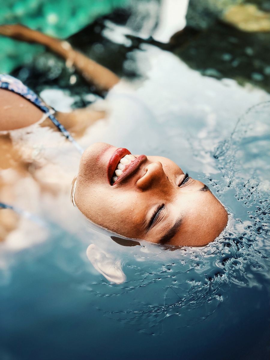 floating woman on body of water