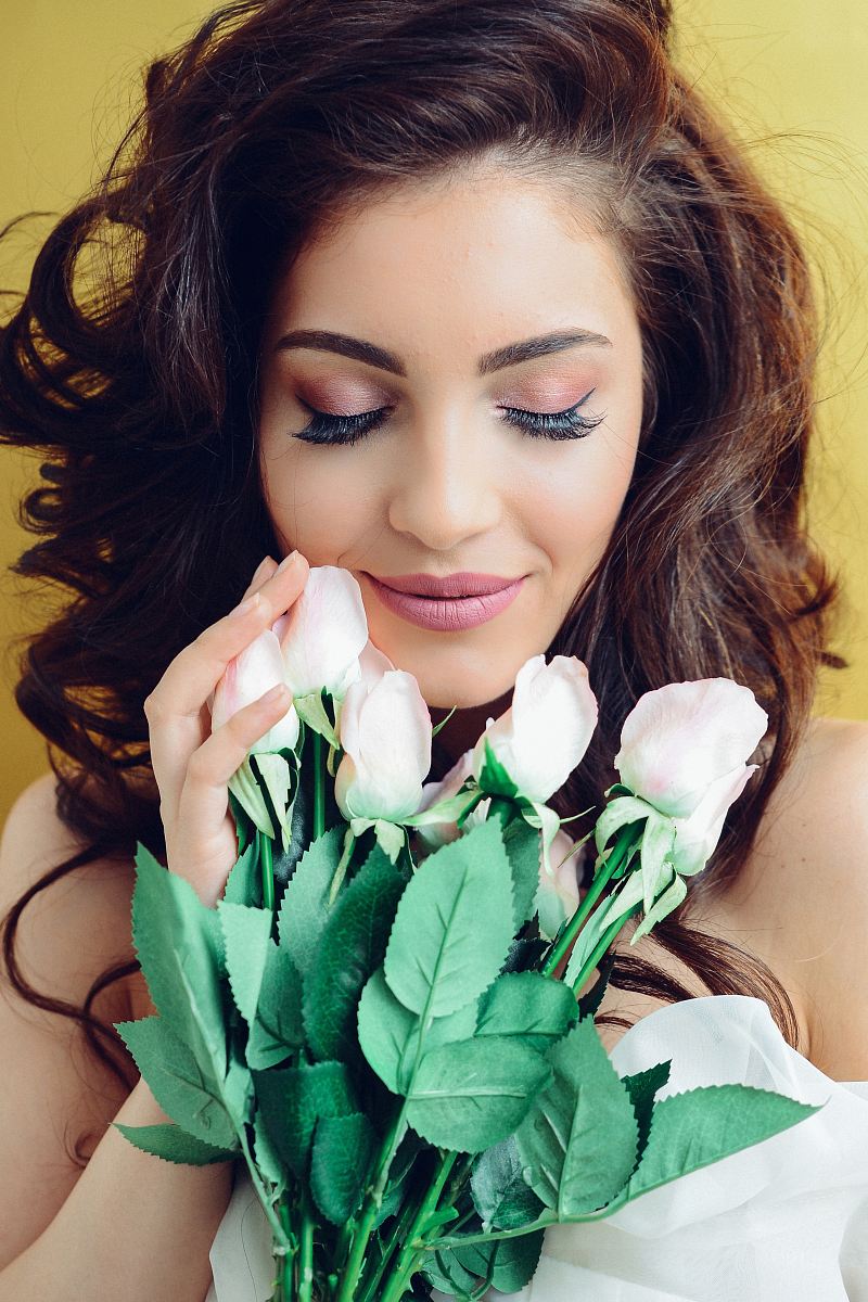 woman touching white rose bouquet