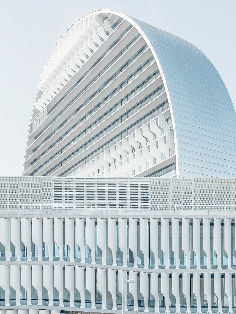 white mirrored building under blue sky arch
