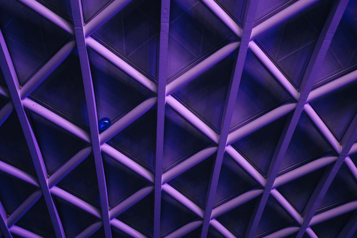 pattern A violet ceiling with a criss-cross pattern; a blue balloon is stuck in the corner one of the crossbars purple