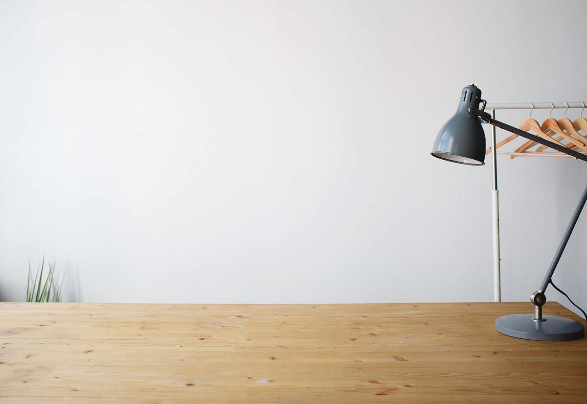 desk gray balanced-arm lamp on brown wooden table wood