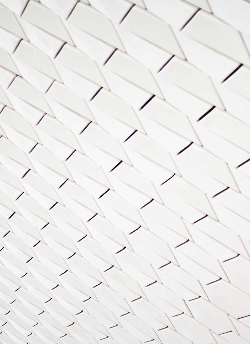 white A pattern of white geometric shapes in a facade pattern