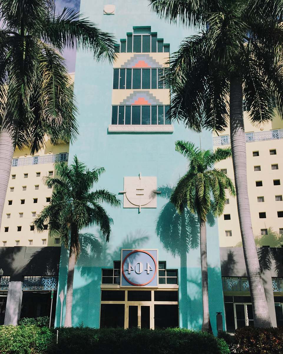 hotel blue 404 concrete building with coconut trees in frontt palm tree