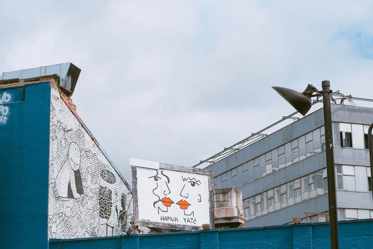 architecture white and grey wooden billboard near white concrete building grey