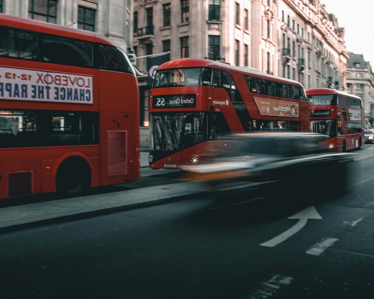transportation speeding car on the road near double decker buses vehicle