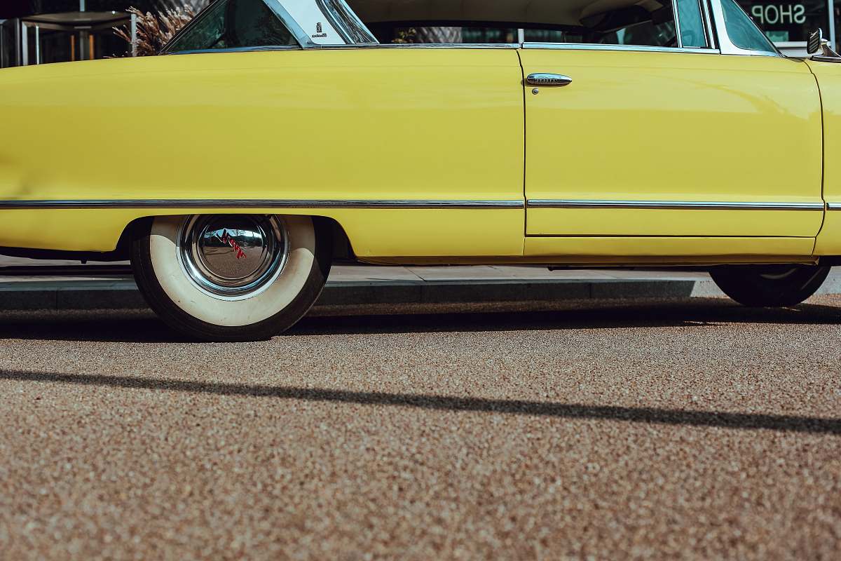automobile photo of yellow coupe on road transportation