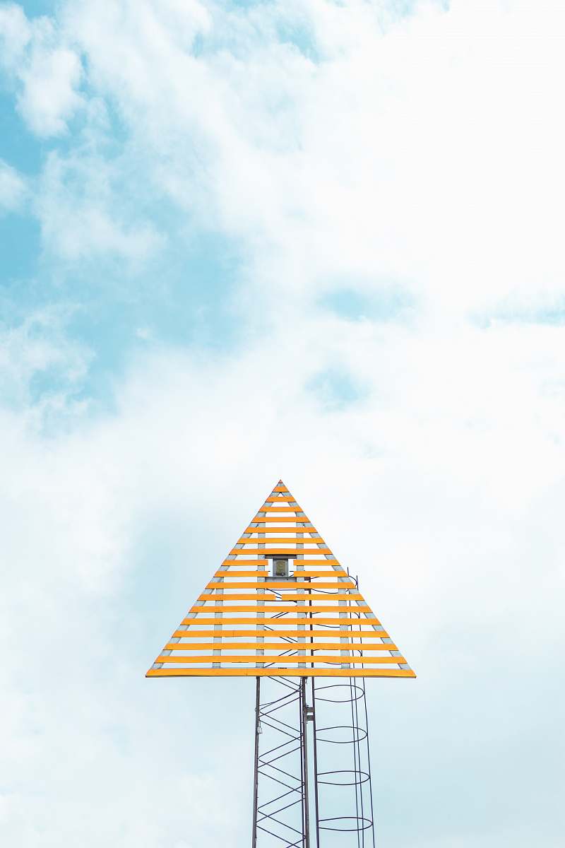 tower closeup photo of triangle tower with cloudy sky structure