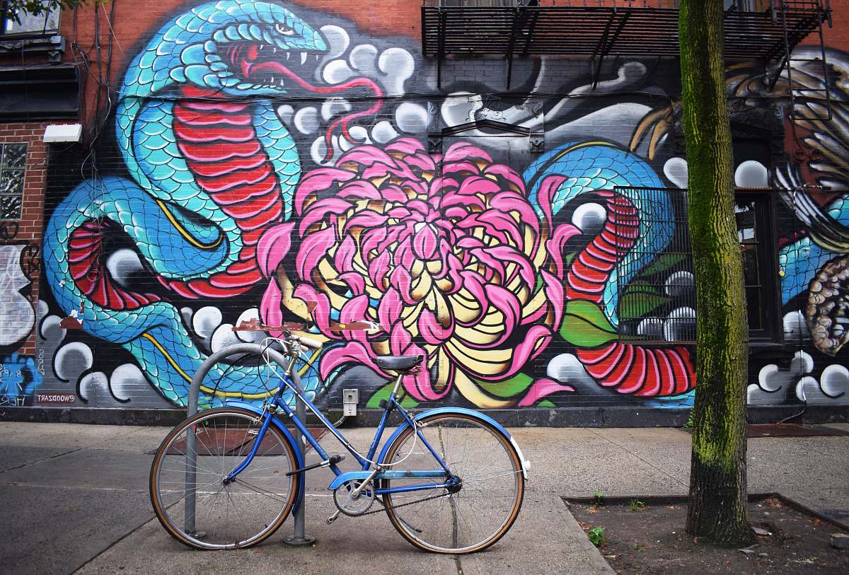 bike blue bicycle parked near graffiti brooklyn
