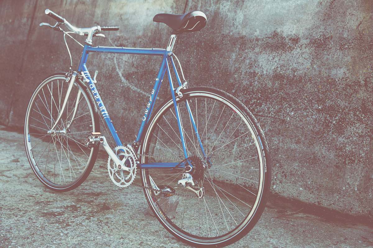 bicycle blue and gray rigid bicycle parked beside wall bike