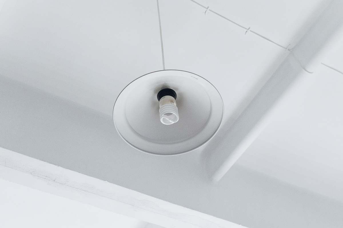 light photo of white light bulb on ceiling lamp