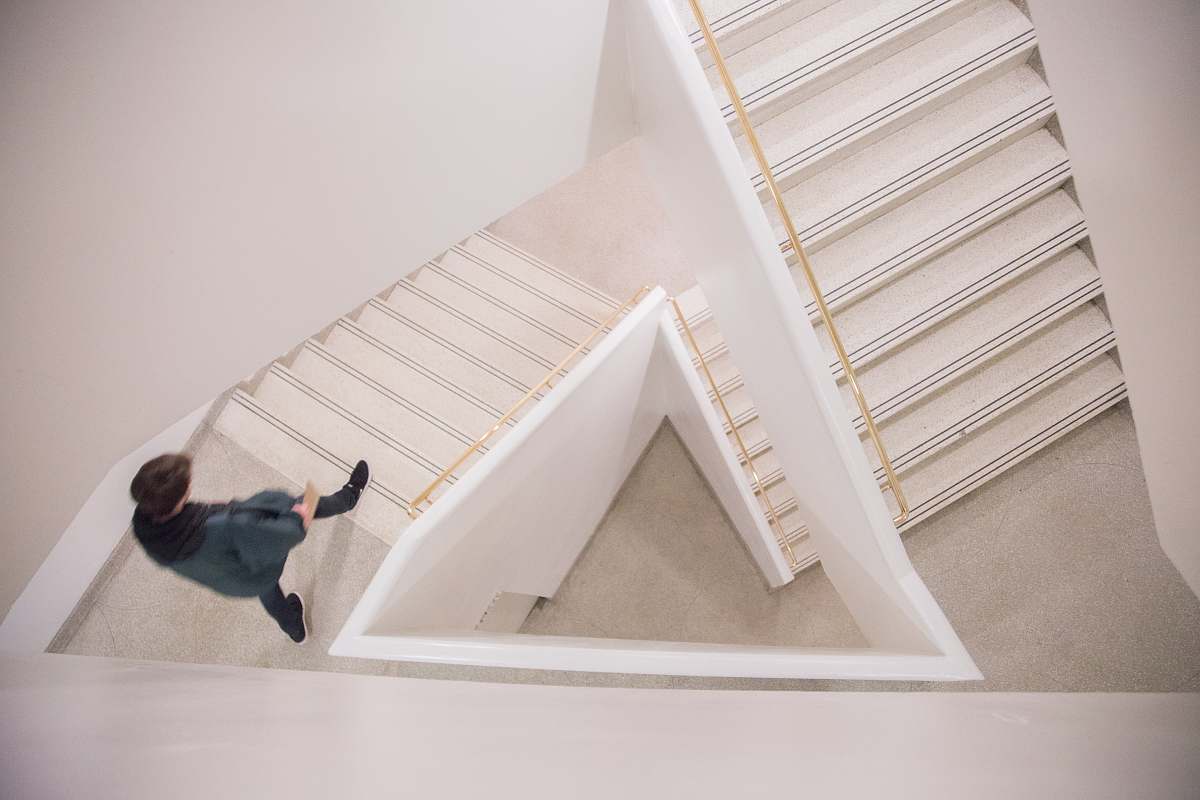 stairwell walking person on white concrete stairs guggenheim
