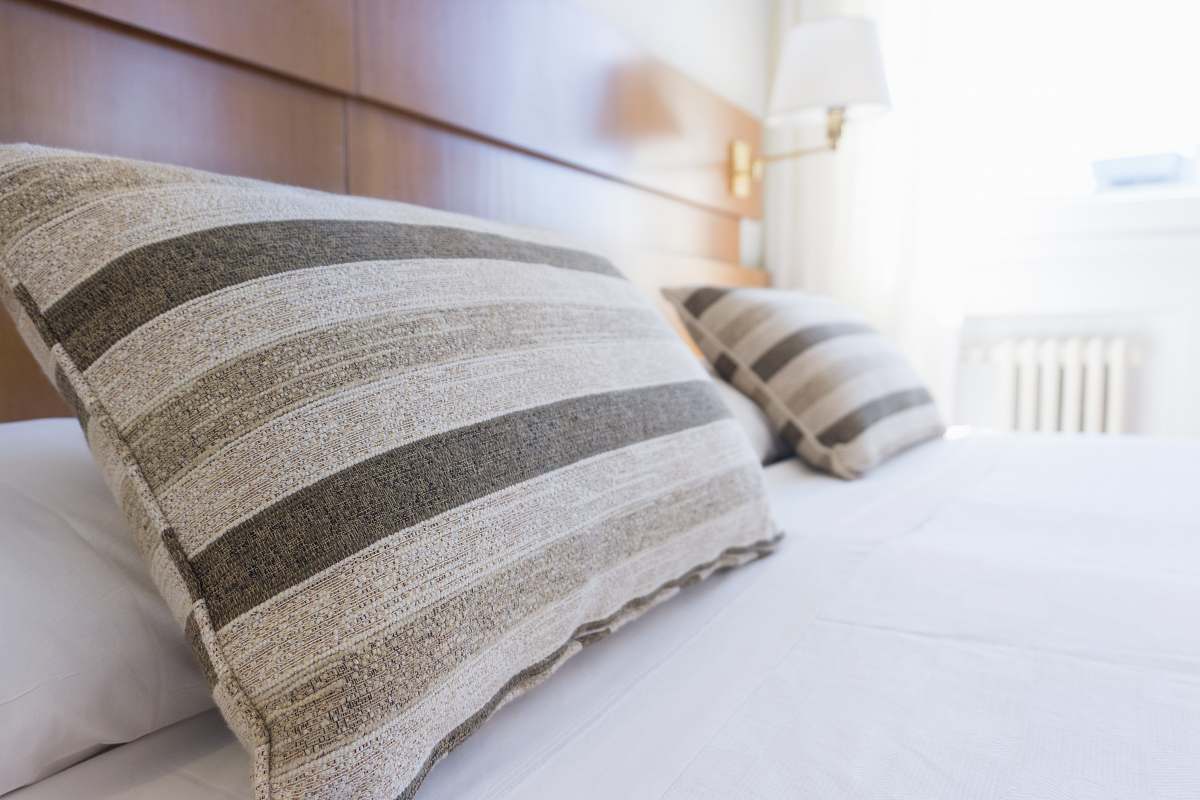 interior gray and black throw pillow on bed bedroom