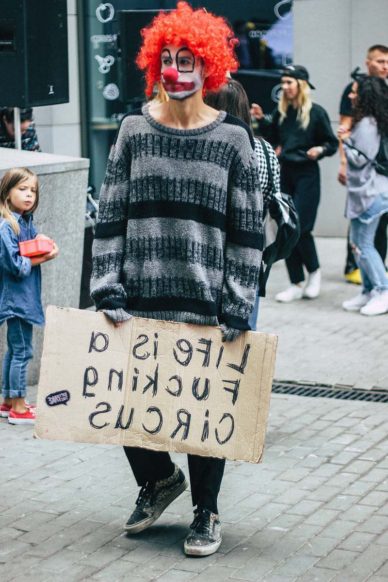 apparel man in grey and black striped sweater holding signage clothing