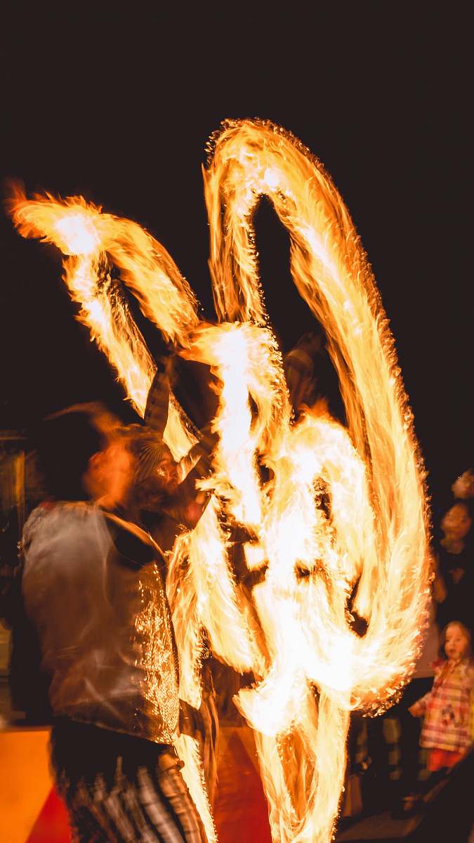 fire man performing fire dance flame