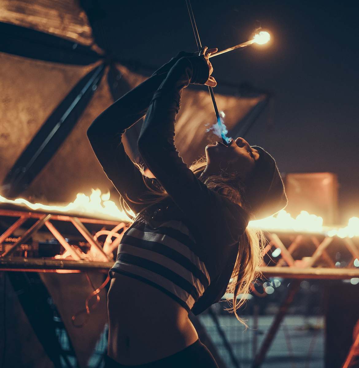 person woman doing fire performance on stage people