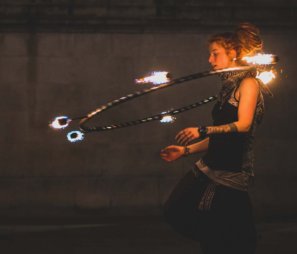 person woman doing hola hoop on neck duel