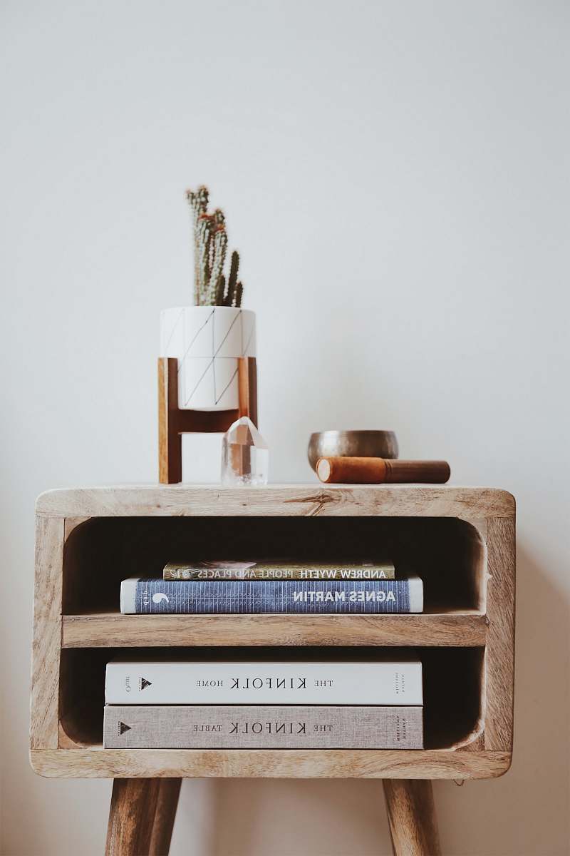 Home Books In Brown Wooden Side Table Beside White Wall Design Image ...