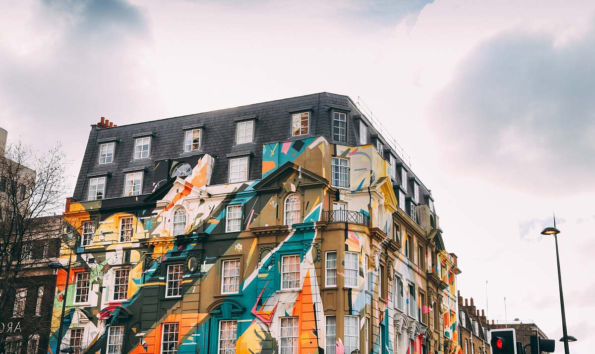 building low-angle photography of building with art painting painting