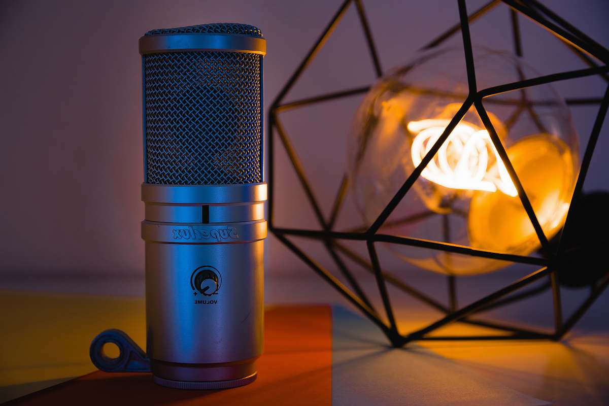 mic grey Superdux device beside black metal framed lamp lightbulb