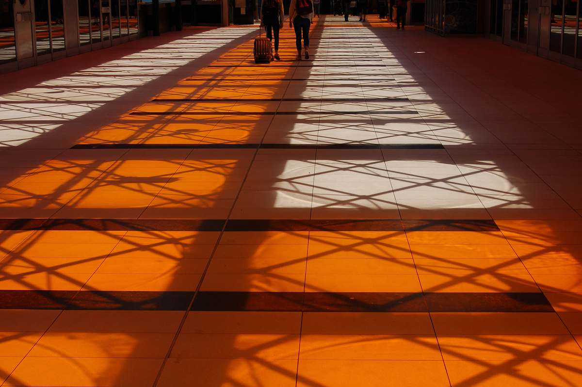 cloud two person walking inside building with orange floor design