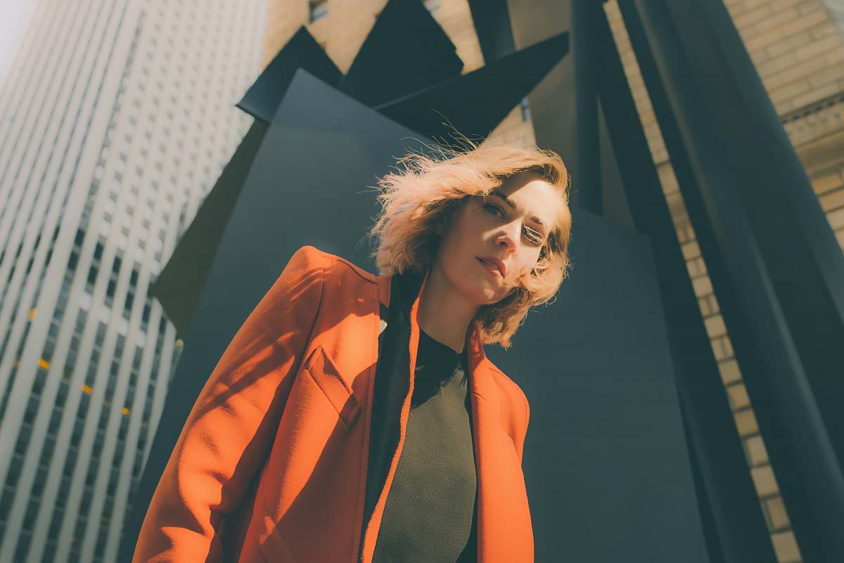 person woman in orange suit jacket human