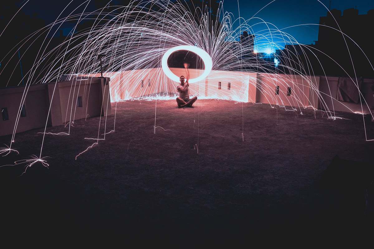 human man standing on surface in steel wool photography leisure activities