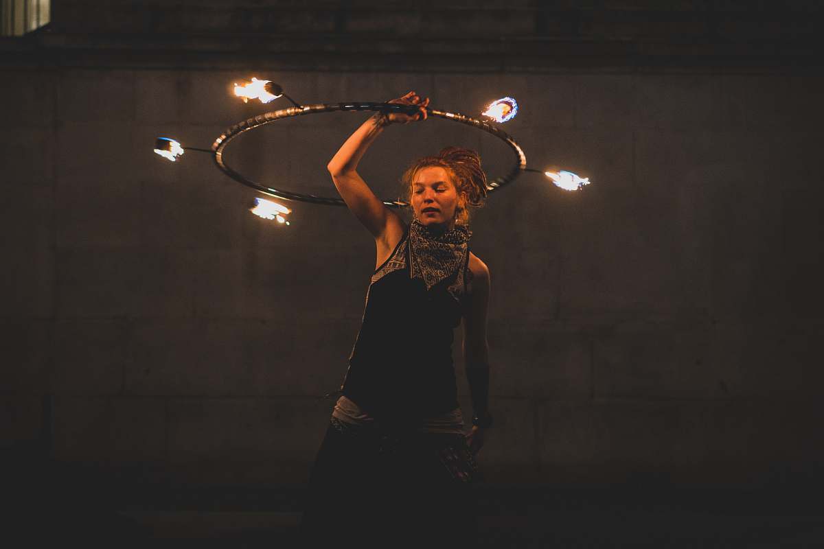 human woman performing fire dancing juggling