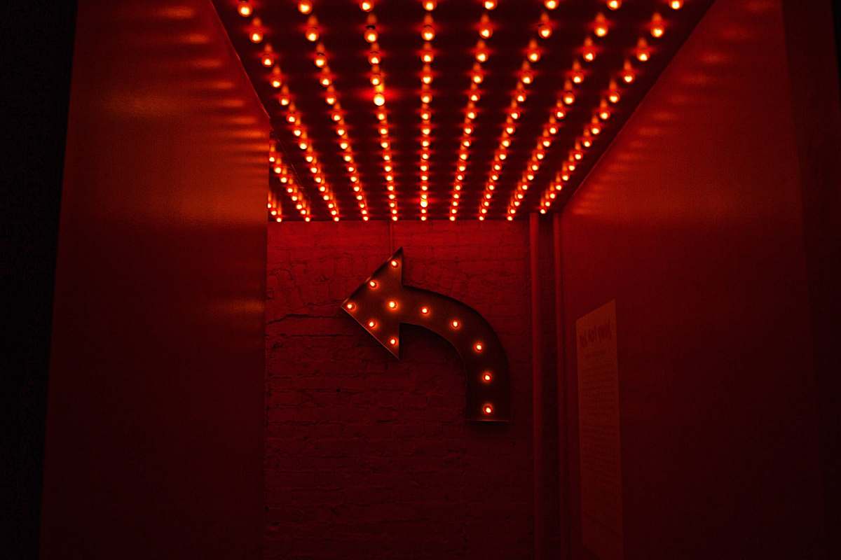neon red marquee light going right light