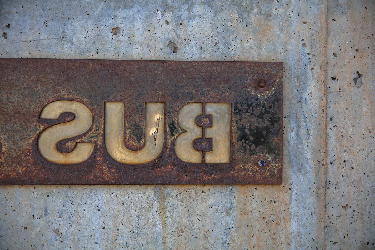 rust brown bus signage installed on wall vintage