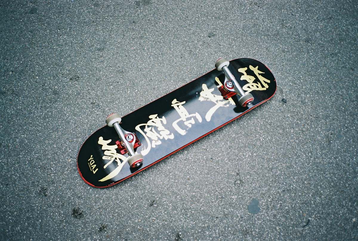 road black skateboard on gray surface trucks