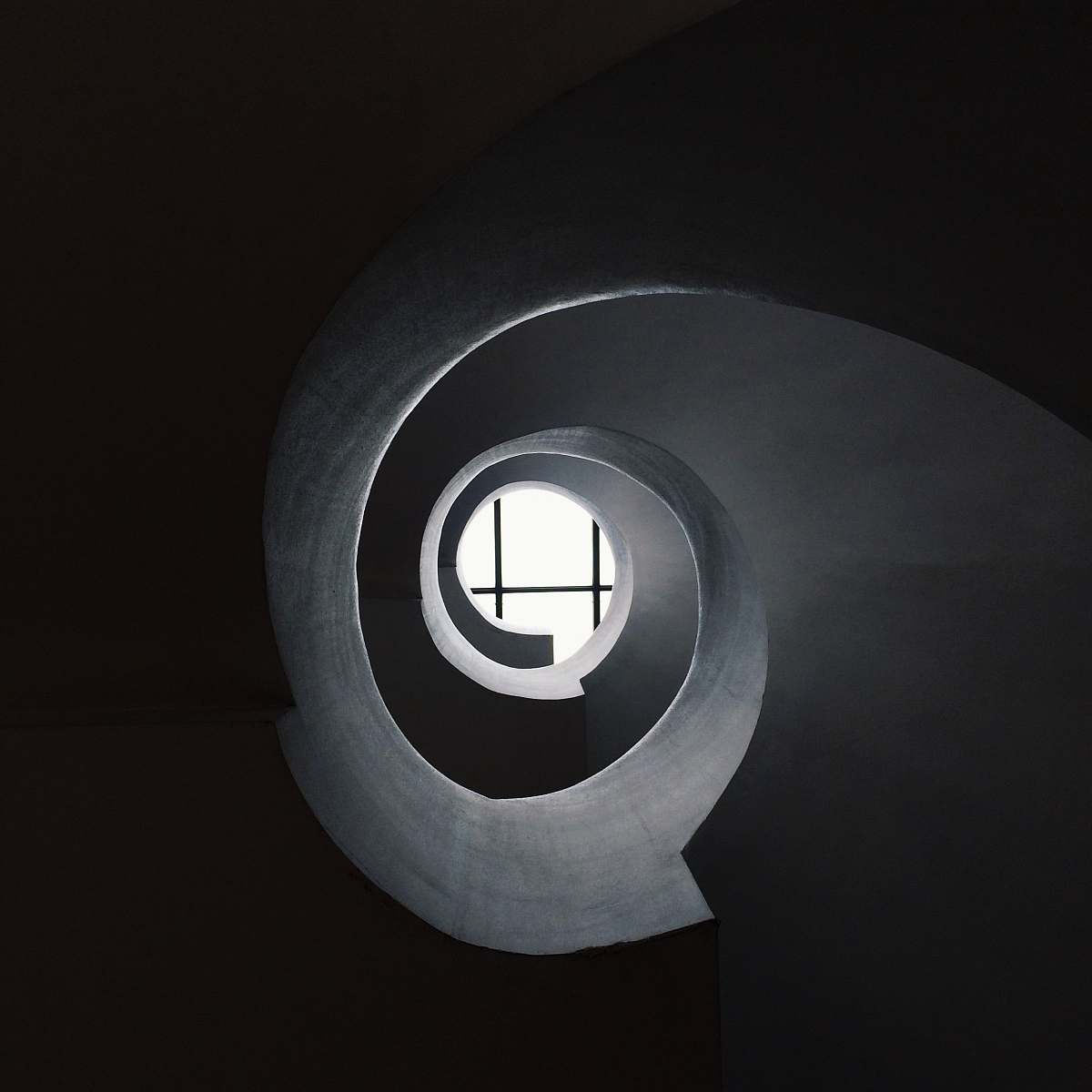window bottom view of concrete spiral stair abstract