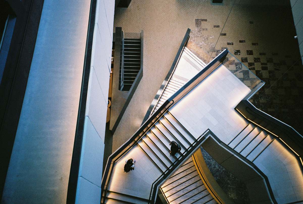 architecture closeup photo of two person on stair building