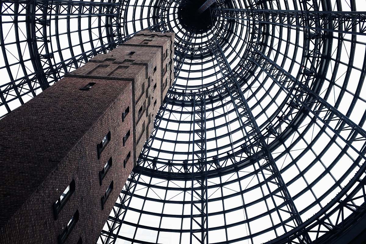 melbourne low-angel photography of gray concrete tower with windows ceiling