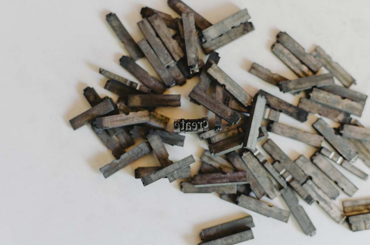 create closeup photo of clothespin lot on white surface letterpress