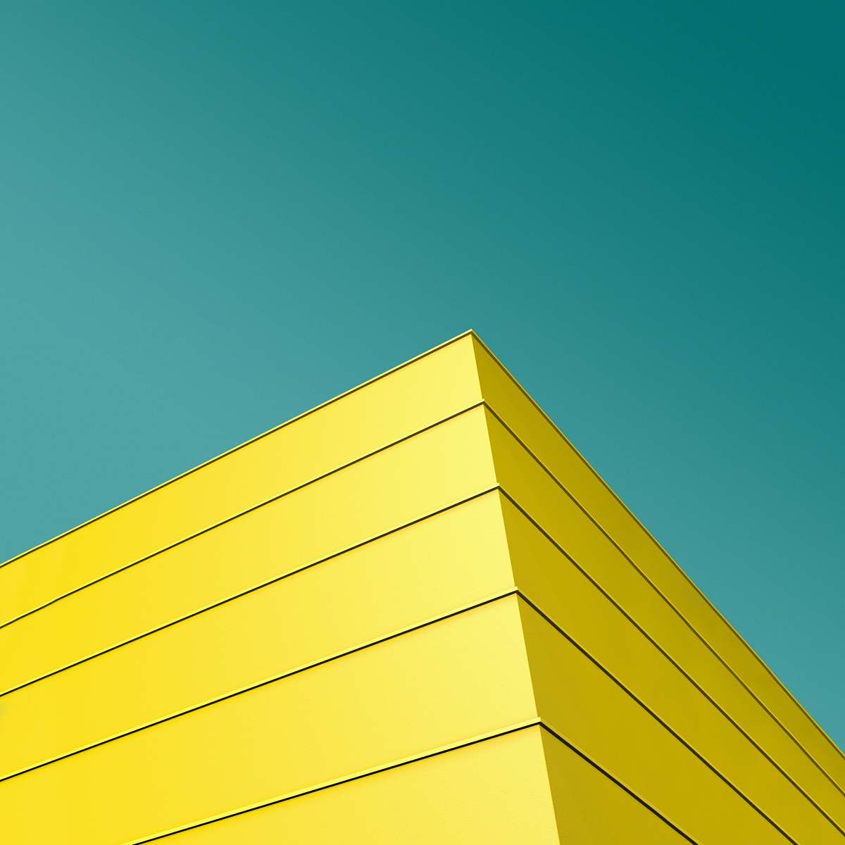 building low angle photo of yellow and black striped building's corner triangle