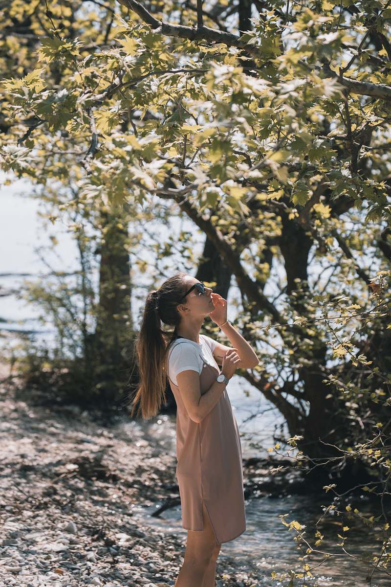 people woman holding black sunglasses looking on the tree human