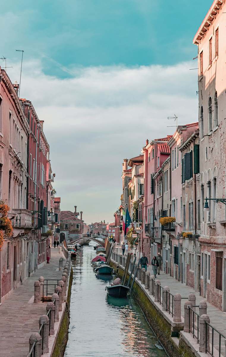 canal body of water between concrete buildings outdoors