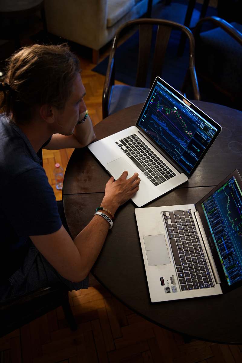 electronics man sitting in front of the MacBook Pro pc