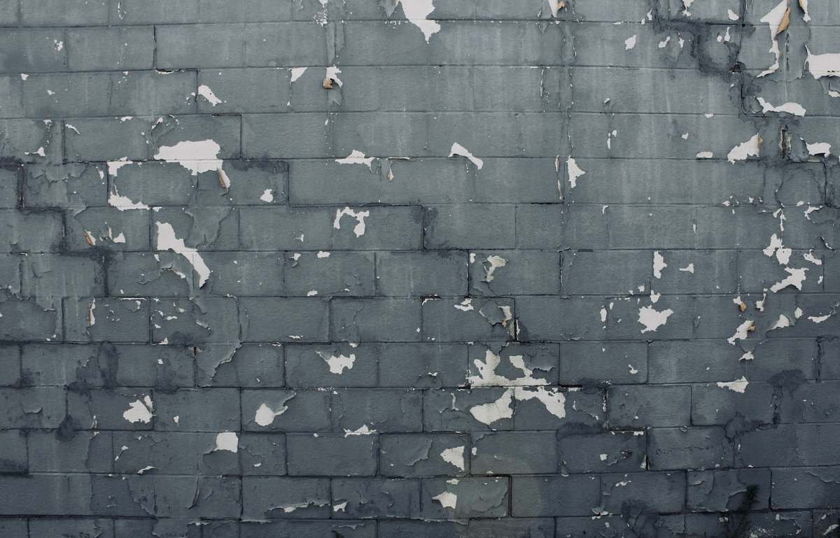 person gray concrete brick wall grey